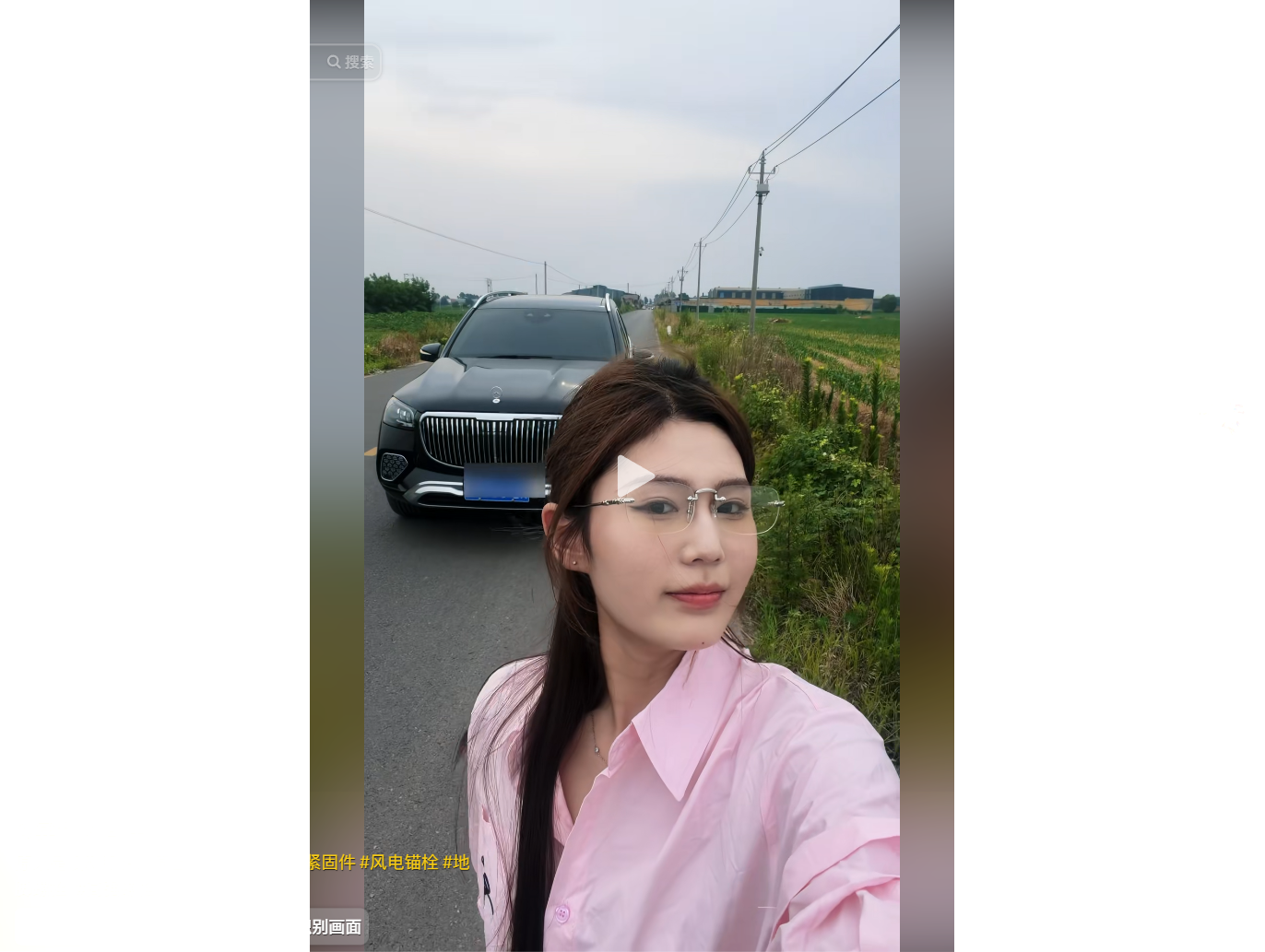 A woman in a pink shirt takes a selfie on a rural
