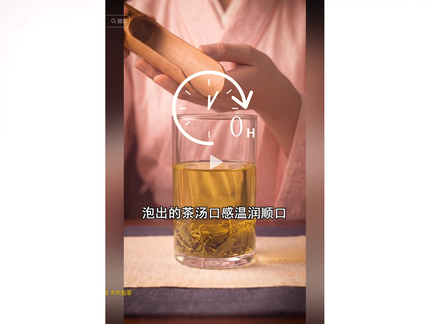 A person pours tea leaves into a glass of water, w