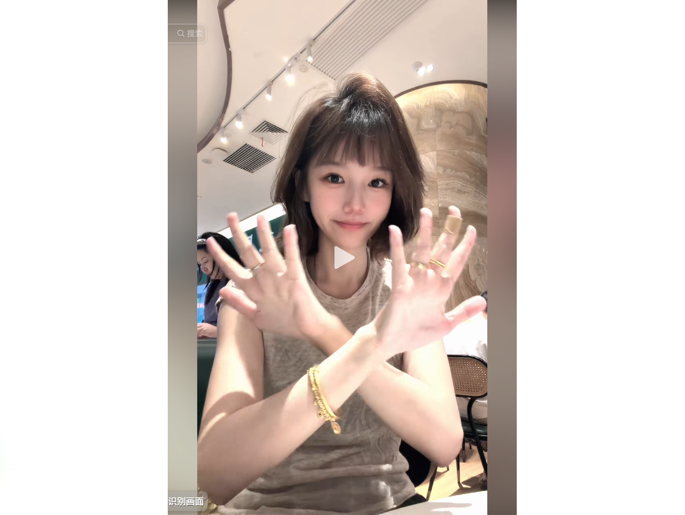 A young woman smiles while showing her hands adorn